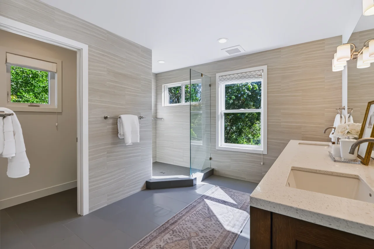 Bathroom with a freestanding bathtub beneath a garden-facing window